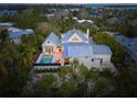Aerial view showcasing a home's waterfront location and pool at 689 Lands End Dr, Longboat Key, FL 34228