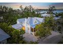 Stunning aerial view of a charming waterfront home with a private pool at 689 Lands End Dr, Longboat Key, FL 34228