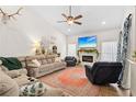 Spacious living room with a fireplace, large TV, and comfortable seating at 7737 40Th E Ct, Sarasota, FL 34243