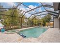 Enclosed pool area with spa and patio at 7737 40Th E Ct, Sarasota, FL 34243