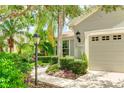 Landscaped walkway leading to a house entrance at 11662 Old Cypress Cv, Parrish, FL 34219