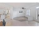 Bright living room with an open floor plan, showcasing a kitchen at 11813 Holly Hock Dr, Lakewood Ranch, FL 34202