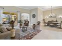 Spacious living room with a view to the dining area and access to the pool at 1227 Tuscany Blvd, Venice, FL 34292