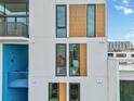 Close-up view of building's exterior with wood and window details at 1558 4Th St # 402, Sarasota, FL 34236