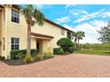 Inviting side entry with brick paver walkway and landscaping at 206 Bella Vista Ter # 29B, North Venice, FL 34275