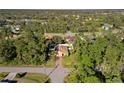 House in a residential neighborhood with lush greenery at 2200 Pratt Avenue, North Port, FL 34286