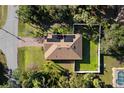 Home with solar panels on roof, surrounded by trees at 2200 Pratt Avenue, North Port, FL 34286