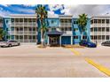 A blue building with balconies and a covered entrance, ample parking is available at 2630 Coconut Bay Ln 2C # 623, Sarasota, FL 34237