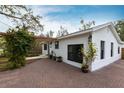 White house with black windows and brick driveway at 2826 Marlette St, Sarasota, FL 34231