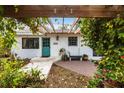 Charming home exterior with teal door and brick patio at 2826 Marlette St, Sarasota, FL 34231