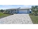 Newly renovated home featuring a paver driveway and curb appeal at 308 Matisse E Cir, Nokomis, FL 34275