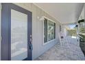 Inviting front porch with rocking chairs and updated door at 308 Matisse E Cir, Nokomis, FL 34275