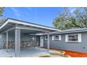 Exterior view of a renovated home with a carport and stone accents at 3419 27Th Pkwy, Sarasota, FL 34235
