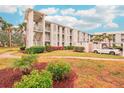 Building exterior with landscaping and parking area at 404 Cerromar N Cir # 108, Venice, FL 34293