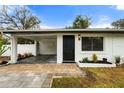 Modern curb appeal with a covered carport and stylish front door at 4042 Radnor Pl, Sarasota, FL 34233
