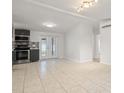 Open concept kitchen and dining area feature stainless steel appliances and tile flooring at 4042 Radnor Pl, Sarasota, FL 34233