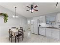 Bright kitchen with white cabinets, granite counters, and a dining area at 4363 Melis St, Port Charlotte, FL 33948