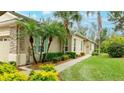 Landscaped yard with a spacious driveway and walkway at 4820 Lakescene Pl, Sarasota, FL 34243