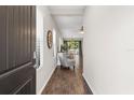 Home entryway with dark door, hardwood floors, and view into living area at 491 Casalino Dr, Nokomis, FL 34275
