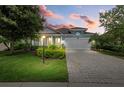Curb appeal of a charming one-story house with a brick driveway at 5307 Applegate Ct, Bradenton, FL 34211