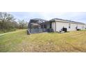 Screened lanai and backyard with grassy area at 6614 162Nd E Pl, Parrish, FL 34219