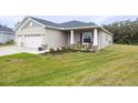 Two-car garage and nicely landscaped front yard at 6614 162Nd E Pl, Parrish, FL 34219