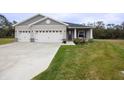 Two-car garage and neatly landscaped front yard at 6614 162Nd E Pl, Parrish, FL 34219