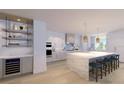Modern kitchen with island, wine cooler, and high-end appliances at 70 Avenida Veneccia # 202, Sarasota, FL 34242