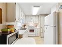 Functional kitchen featuring white appliances, ample cabinet space, and a bright, clean aesthetic at 703 Corsica Ct, Bradenton, FL 34207