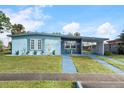 Charming light blue house with a carport and well-manicured lawn at 8466 Maureen Ave, North Port, FL 34287