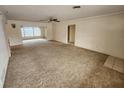 Spacious living room featuring carpeted floors and a ceiling fan at 975 S Tuttle Ave, Sarasota, FL 34237