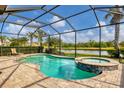 Relaxing pool and spa with screened enclosure and water view at 11241 Sandhill Preserve Dr, Sarasota, FL 34238