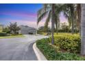 Residential home with a curved driveway and lush landscaping at 11808 Sawgrass Lake Ter, Bradenton, FL 34211