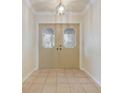 Bright entryway with tiled floor and double doors at 1313 Harbor Blvd, Port Charlotte, FL 33952