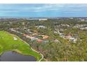 Community overview featuring a golf course, water features, and numerous houses at 135 N Creek Ln, Osprey, FL 34229