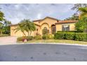 Beautiful house with a three-car garage, palm trees, and well-maintained landscaping at 135 N Creek Ln, Osprey, FL 34229