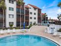 Ground level view of condo building and inviting pool area at 1604 Stickney Point Rd # 102, Sarasota, FL 34231