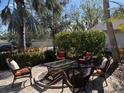 Cobblestone patio with wicker furniture and fire pit at 1666 Pintail Way # 9, Sarasota, FL 34231