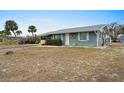 Gray house with white accents and a life preserver near the door at 1956 Massachusetts Ave, Englewood, FL 34224