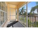 Screened balcony offering peaceful views of tropical foliage at 200 Mirabella Cir # 201, Venice, FL 34292