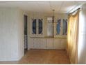 Dining room with built-in hutch and wood paneling at 232 Trailorama Dr, North Port, FL 34287