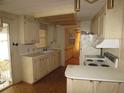 Galley kitchen with light wood cabinets and appliances at 232 Trailorama Dr, North Port, FL 34287