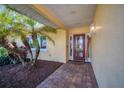 Covered entryway with a glass front door and a welcoming atmosphere at 2424 Post Rd, Sarasota, FL 34231