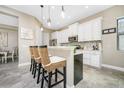 Modern kitchen with white shaker cabinets and a large island at 26858 Weiskopf Dr, Englewood, FL 34223