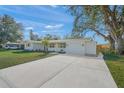 Newly renovated home with a spacious driveway and mature trees at 3054 Markridge Rd, Sarasota, FL 34231