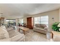 Living room with light beige couches and wood cabinet at 318 Barlow Ave # 71, Sarasota, FL 34232