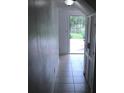 Simple entryway with tile floor and door to backyard at 406 Barlow Ave # 65, Sarasota, FL 34232