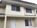 Tan two-story building with white door and windows at 406 Barlow Ave # 65, Sarasota, FL 34232