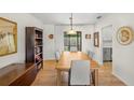 Bright dining room with a large wooden table and view into the kitchen at 4410 Little John Trl, Sarasota, FL 34232