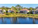 Home with a screened lanai overlooking a tranquil lake at 7220 Kensington Ct, University Park, FL 34201